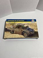 Front of the box showing the model kit name and scale with image of painted assembled model on desert background.