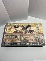 Closed box of Italeri El Alamein Railway Station model kit, showing box art featuring WWII soldiers and battle scene.