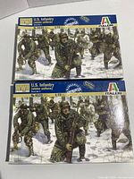 Two unopened boxed sets of Italeri 1:72 scale WWII U.S. Infantry miniature figures in winter uniform, model 6133, front view showing box art.