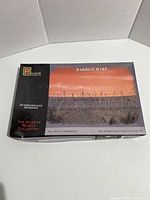 Front view of the closed box showing the 'Barbed Wire' model kit from Pegasus with artwork of barbed wire fencing at sunset, labeled as part of The Museum Models Collection.