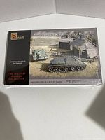 Front view of the sealed model kit box showing Su-122 tank and two T-34 tanks in a military diorama scene.