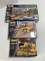 Three Revell military model kits stacked: Jagdpanther with German pioneers (1:72 scale), Sd.Kfz. 7 with 7.5 cm PaK 40 (1:76 scale), and Sd.Kfz. 124 WESPE (1:76 scale). Box art and details visible.