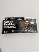 Front view of boxed paint set with labeled German Field Grey colors and illustrated German soldier figure.