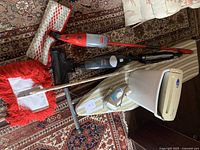 Group shot showing Vileda spray mop, Bissell MagicVac, dust mop, Fellowes shredder, ironing board and Sunbeam iron