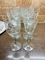Group of six etched crystal water goblets and two smaller stems