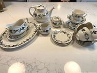 All Royal Doulton Burgundy pieces arranged on countertop