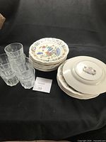 Stack of Rouen plates and six Ikea tumblers