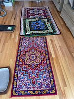 Three area rugs displayed on hardwood floor, showing full length of each rug in various arrangements.