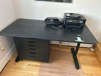 Full black desk with storage drawers, radio and printer on top (not included) showing size and design.