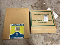 Two cardboard boxes of light boxes including Light Photo Box K and Fujicolor Light Box 8W AAA.