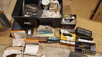 Overview of bins containing assorted track sections, power controller, and other accessories