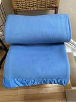 blue wool blanket folded showing satin binding