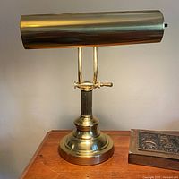 Full view of brass barrister lamp on table