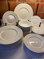 Front view of stacked dinner plates, luncheon plates, dessert plates and cereal bowls in Athena pattern