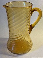 Full view of amber swirl glass pitcher front side