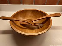 Salad bowl with spoon and fork inside