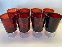 Front view of seven ruby red stemmed glasses
