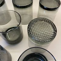 Top and bottom view showing smoky tint and textured woven pattern on base