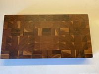 Top view of end-grain cutting board showing multi-wood pattern