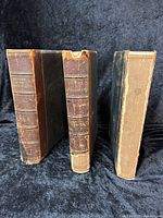 Three antique hardcover books, History of the United States by Samuel E Knapp and William A Crafts, Vol I, II, and III, showing worn leather spines and cloth covers.