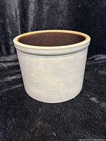 Overall front view of farmhouse stoneware crock showing smooth gray exterior and light rim