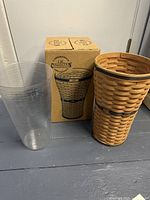 Longaberger umbrella basket with plastic liner and original box on gray floor