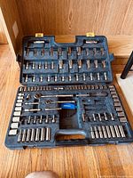 Full open case showing organized ratchets, sockets, extensions, and accessory bits.