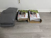 Three Coleman air mattresses shown, with two boxed twin size Quickbed air mattresses and one queen size mattress folded next to the boxes.