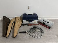 Overview of lot showing rod bags, two tackle boxes, landing net and fish gripper