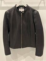 Full front view of jacket hanging on white hanger