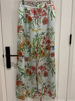 Full view of the wide leg pants showing the floral pattern and light blue background color.