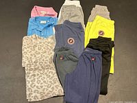 Overhead view of all clothing items laid out on black surface