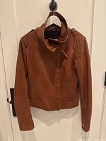 Front full view of jacket hanging to show overall style and silhouette