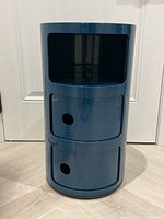 Front view showing open top compartment and two lower compartments with sliding doors closed