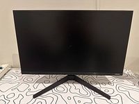 Front view of Samsung 24 inch monitor on stand showing slim bezels and screen.