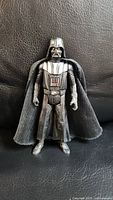 Front view of the 2013 Star Wars Darth Vader figure showing detailed chest panel and black fabric cape.