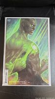 Full front view of the Dark Nights: Death Metal #4 comic book with Artgerm variant cover, showing the muscular character with green glowing effects.