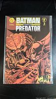Front cover of Batman Versus Predator Issue #2 showing Batman and Predator in battle.