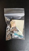 Luke Skywalker Hoth minifigure in plastic bag showing figure and blue lightsaber accessory.