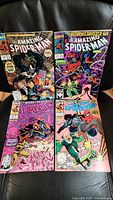 Top view showing all 4 Amazing Spider-Man comic books in the lot clearly visible with colorful covers and titles.
