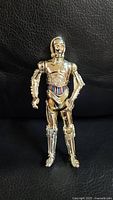 Front view of the gold C-3PO figure showing detailed articulation and midsection wiring details.