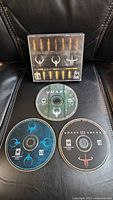 Photo of Ultimate Quake game case with bullet design and three PC game discs for Ultimate Quake, Quake II, and Quake III Arena.