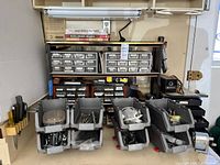 Shelving unit with plastic bins holding small hardware, books and pencil sharpeners on top shelf