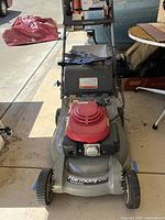 Front view showing mower deck, engine cover and Harmony 215 label