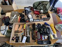 Overview of survival and emergency gear laid out on table