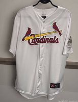 Front view of white baseball jersey with Cardinals logo and 2011 World Series Champions patch.