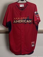 Front view of red and navy blue MLB American League All Star Game jersey, size 44, with 'AMERICAN' wordmark and 2014 All Star Game patch on sleeve.