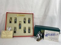 Full view of the set in original foam setter, mounted figure outside with certificate and green box.