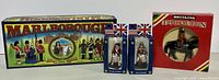 Photo showing the Marlborough Collectors Models box with two colonial drummer miniature soldiers in blue blister packs and Britains The Queen figure in red box, all standing side by side.