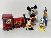 Photo of all five Disney porcelain figurines and train with peppermint candy tin showing size and condition